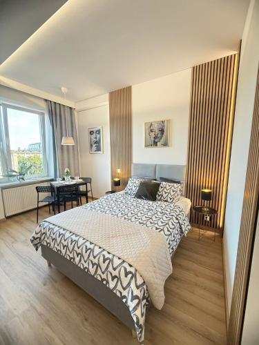 a bedroom with a large bed and a table at Exclusive Apartments Smolna in Warsaw