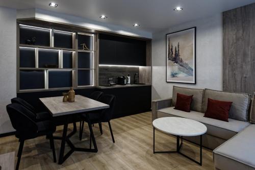 a living room with a couch and a table at Glacier Premium Apartments in Bukovel