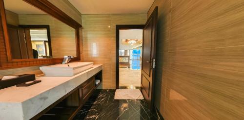 a bathroom with a sink and a mirror at Boton Blue Hotel & Spa in Nha Trang