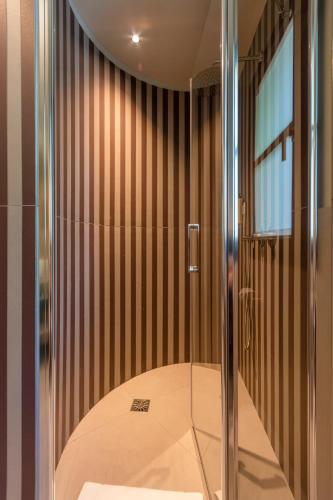 a shower with a glass door in a bathroom at CasaCabe - Boutique Living in Imola