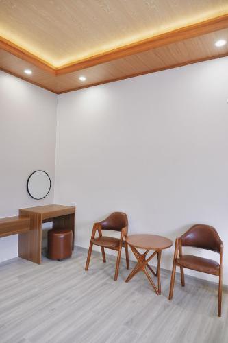 two chairs and a table in a room at Diamond Luxury Hotel & Café Măng Đen in Kon Plong