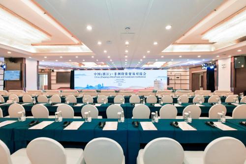 a conference room with a large projection screen at Grand Sun City Hotel-Located city center Metro Access in Changsha