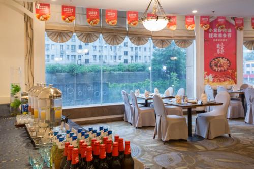 a restaurant with tables and chairs and a large window at Grand Sun City Hotel-Located city center Metro Access in Changsha