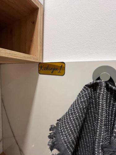 a sign on a cabinet with a curtain hanging from it at Apartmani Venecia in Prozor
