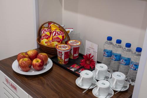 a counter with a tray of food and bottles of water at KLY Hotel Vung Tau in Vung Tau