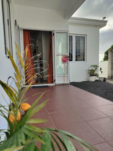 a front door of a house with a plant at Noulakaz, séjour paisible à 10 min de Belle Mare in Argy
