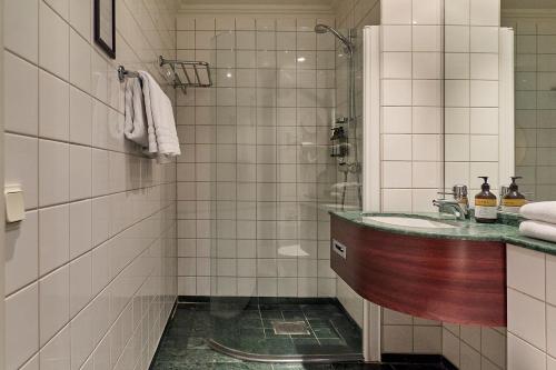 a bathroom with a sink and a shower at Elite Hotel Mollberg in Helsingborg