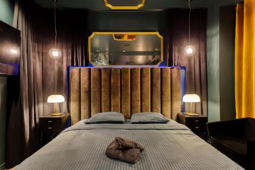 a bedroom with a bed with two slippers on it at La Suite Versailles freeParking table massage Clim in Montreuil