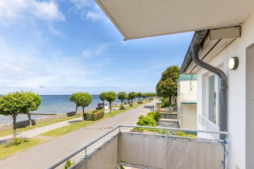a balcony with a view of the ocean at Villa Fördestrand Spinnaker in Laboe