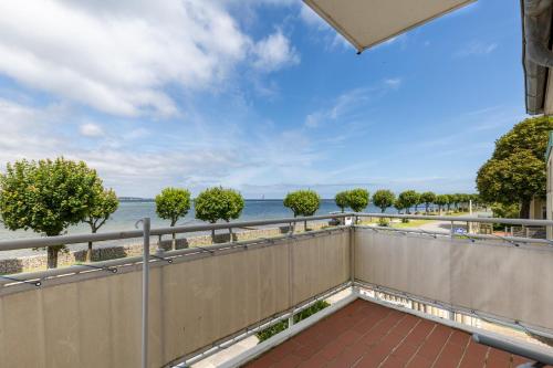 a balcony with a view of the beach at Villa Fördestrand Spinnaker in Laboe