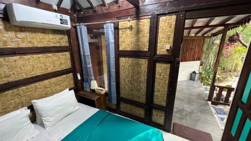 a bedroom with a bed in a room with a window at Tahlia's Villa in Sorongjukung