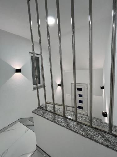 a room with white walls and a mirror at Apartmani Venecia in Prozor