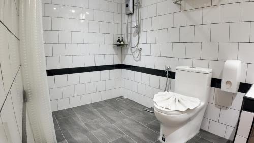 a white bathroom with a toilet and a shower at V1 boutique hotel in Kanchanaburi