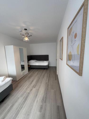 a living room with a bed and a painting on the wall at Ferienwohnung Ilana in Marl