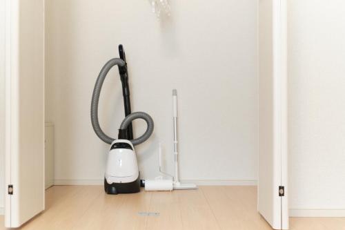 a vacuum cleaner is plugged into a wall at J-ARC Akebonobashi in Tokyo
