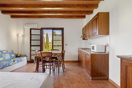 a kitchen with a table and chairs in a room at La Bettola Tavern Rooms Restaurant in Montopoli in Val dʼArno