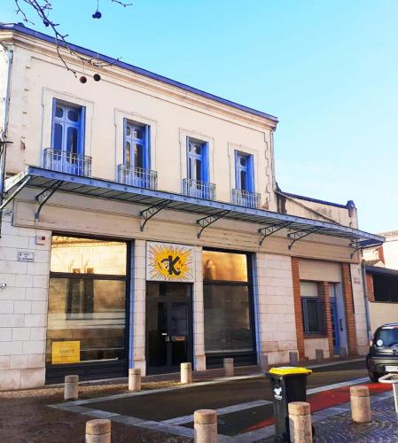 a building with windows on the side of a street at T2 LE SUDISTE in Valence-dʼAgen