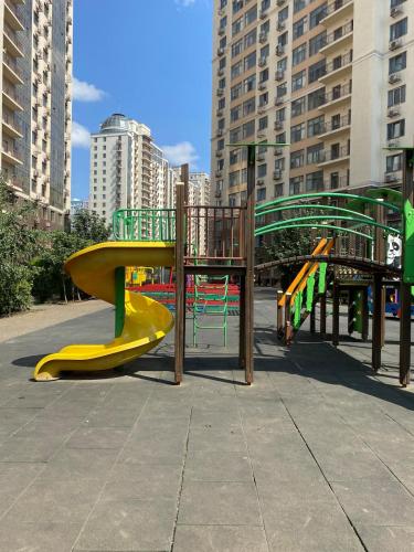 a playground with a yellow and green slide at Evrodvushka in Odesa