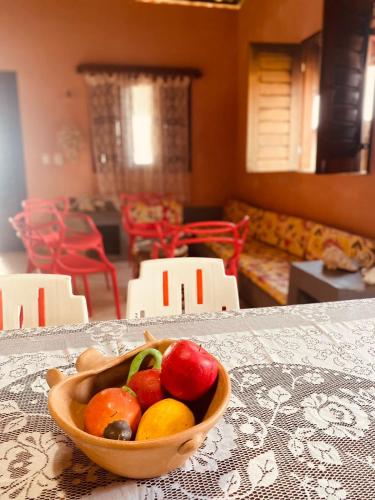 a bowl of fruit sitting on a table at Casa Mar Poesia - Taiba in Taíba