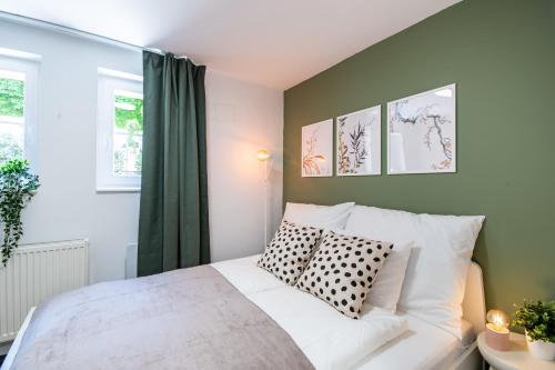 a bedroom with a white bed with two pillows at Central - Green - Stylish - Quiet Sleep in Debrecen