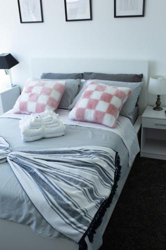 a bed with two pillows on top of it at An entire 3 Bedroom house in Beeston United Kingdom in Beeston