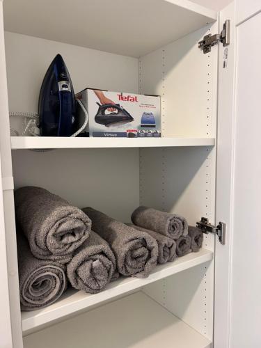 a cupboard with towels on the shelves at Piast Castle Apartment Brzeg in Brzeg