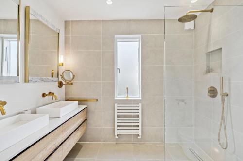 a bathroom with two sinks and a shower at Glade House in Marlow