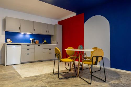 a kitchen with a table and yellow chairs at Artovna České Budějovice in České Budějovice