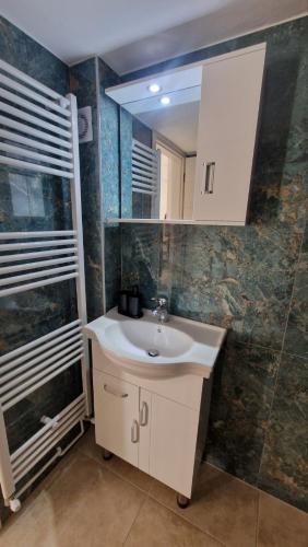 a bathroom with a sink and a mirror at Aegean Horizon Apartment in Skala Marion