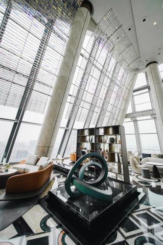 a lobby with a large green sculpture in a building at Pullman Shenzhen North in Shenzhen