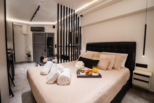 a bedroom with a bed with a tray of food on it at Monte Smith Luxury Suites in Rhodes Town