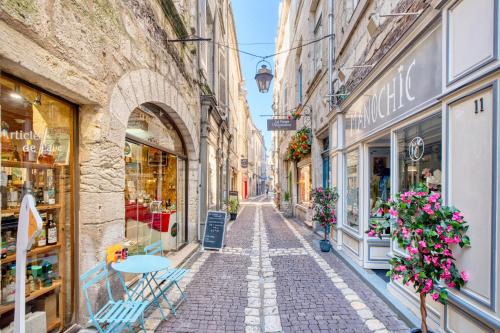 an alley in an old town with shops at L'appartement d'Olympe in Périgueux