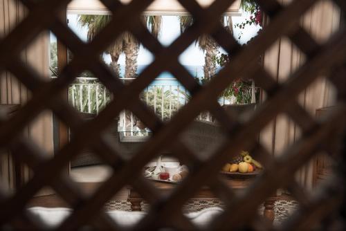 a view through a window of fruit on a table at Hotel Simius Playa in Villasimius