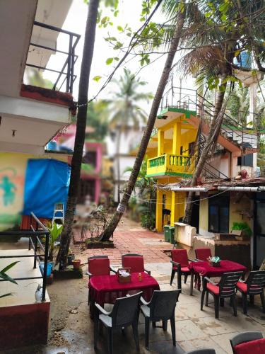 a group of tables and chairs in front of a building at Arambol Residensea in Pernem