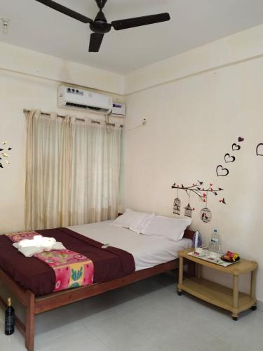 a bedroom with a large bed and a table at Arambol Residensea in Pernem