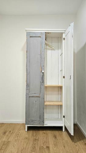 an open cabinet in an empty room at Stará Pekárna/Old Bakery in Znojmo