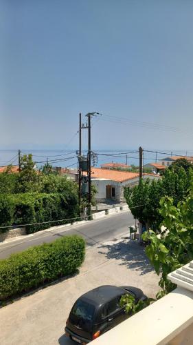 a black car parked on the side of a road at Apartments Zafiria in Ágios Konstantínos