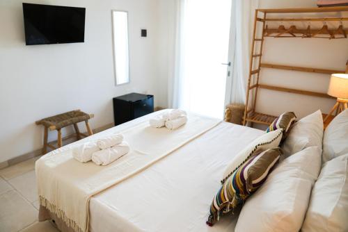 a bedroom with a large white bed and a couch at Fraledune in Maruggio