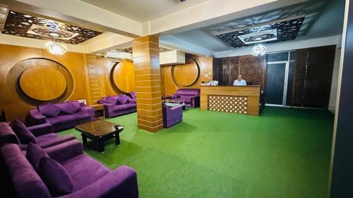 a waiting room with purple couches and mirrors at Platinum Hotel Ltd in Dhaka