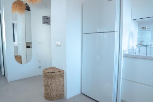 a white room with a refrigerator and a stool at Vacation - Honeymoon House in Ortaca