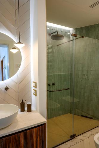 a bathroom with a glass shower and a sink at OraBlu Exclusive Villas in Ischia