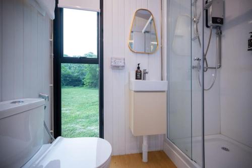a bathroom with a shower and a toilet and a sink at Tiny Away Escape at Lazarus - 1980 in Singapore