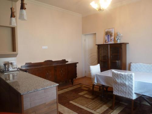 a kitchen and dining room with a table and a counter at Zekorei Guest House in Kutaisi