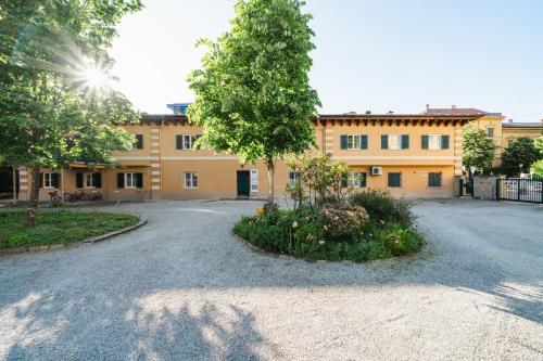 a building with a tree in the middle of a driveway at Blue flat by GrazRentals best location & free parking in Graz