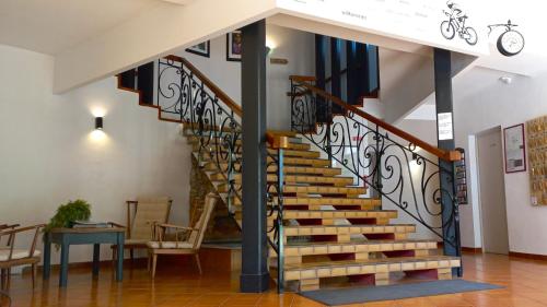 a spiral staircase in a home with a table and chairs at Hôtel Sous l'Olivier in Buis-les-Baronnies