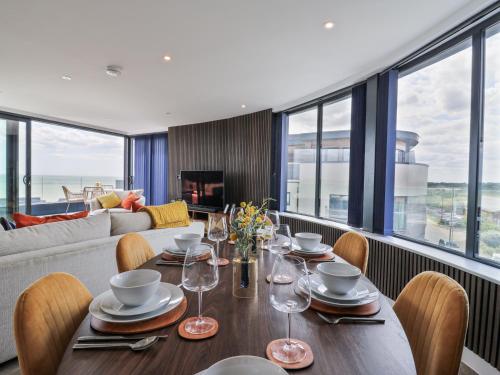 a dining room with a table and chairs at Flat 4 - Penthouse in Hythe
