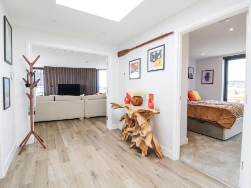 a bedroom with a bed and a living room at Flat 4 - Penthouse in Hythe