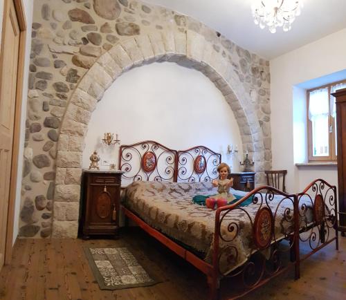 a bedroom with a bed in a stone wall at Agriturismo Odorizzi in Tassullo