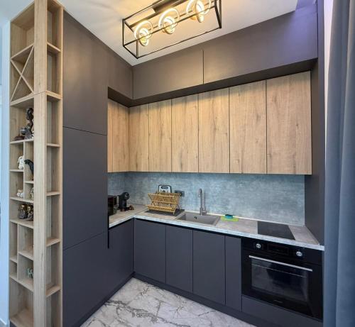 a kitchen with gray cabinets and a sink at Aurum Villas Smokinya Beach 4 in Sozopol