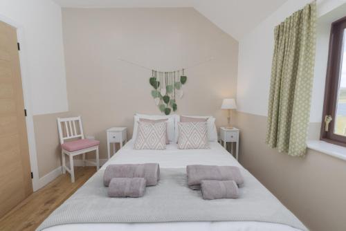 a bedroom with a large bed with two pillows at Setter, Shetland Islands 